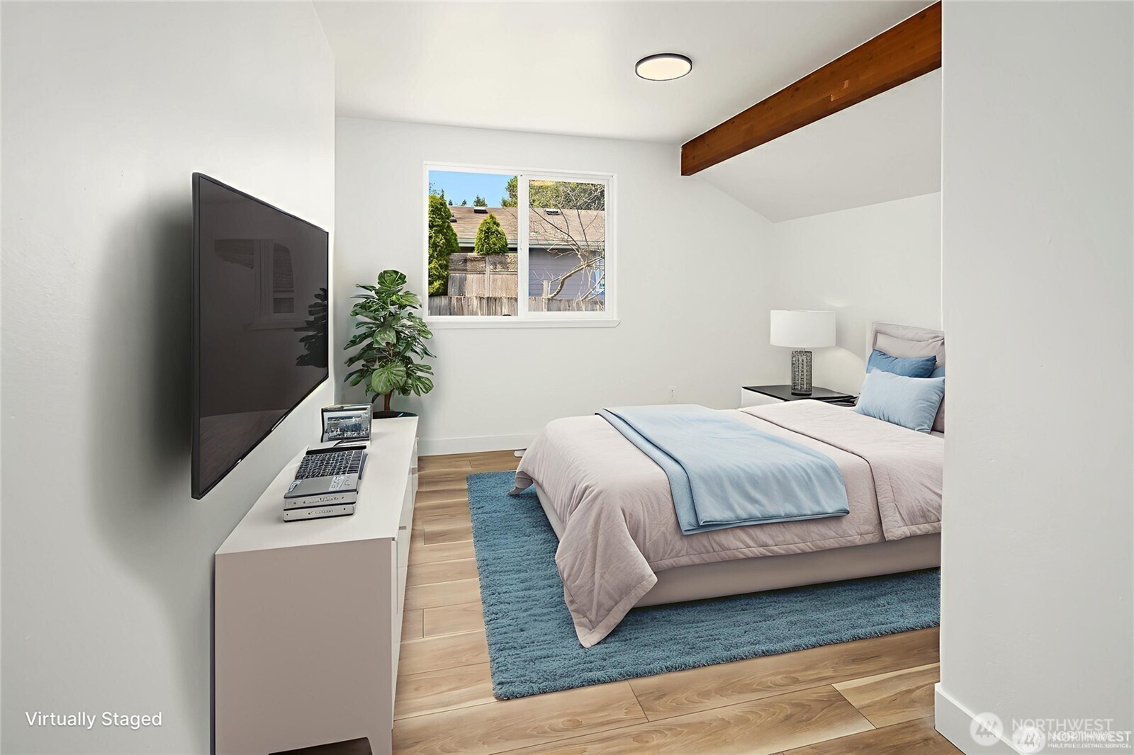 9 76th Street Southeast Everett, WA 98203 - Photo 21 of 28 a bedroom with a flat screen tv a lamp and a bed