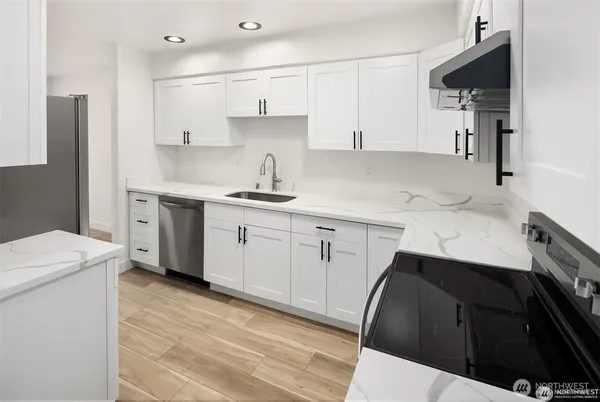 a kitchen with a sink a stove and refrigerator