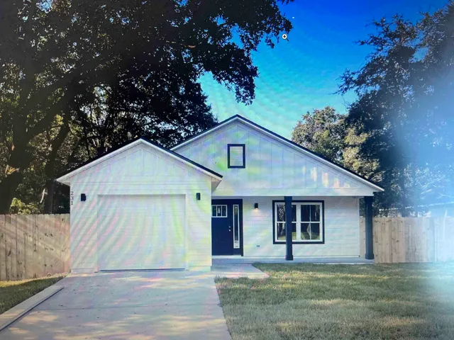 a house that has a tree in front of it