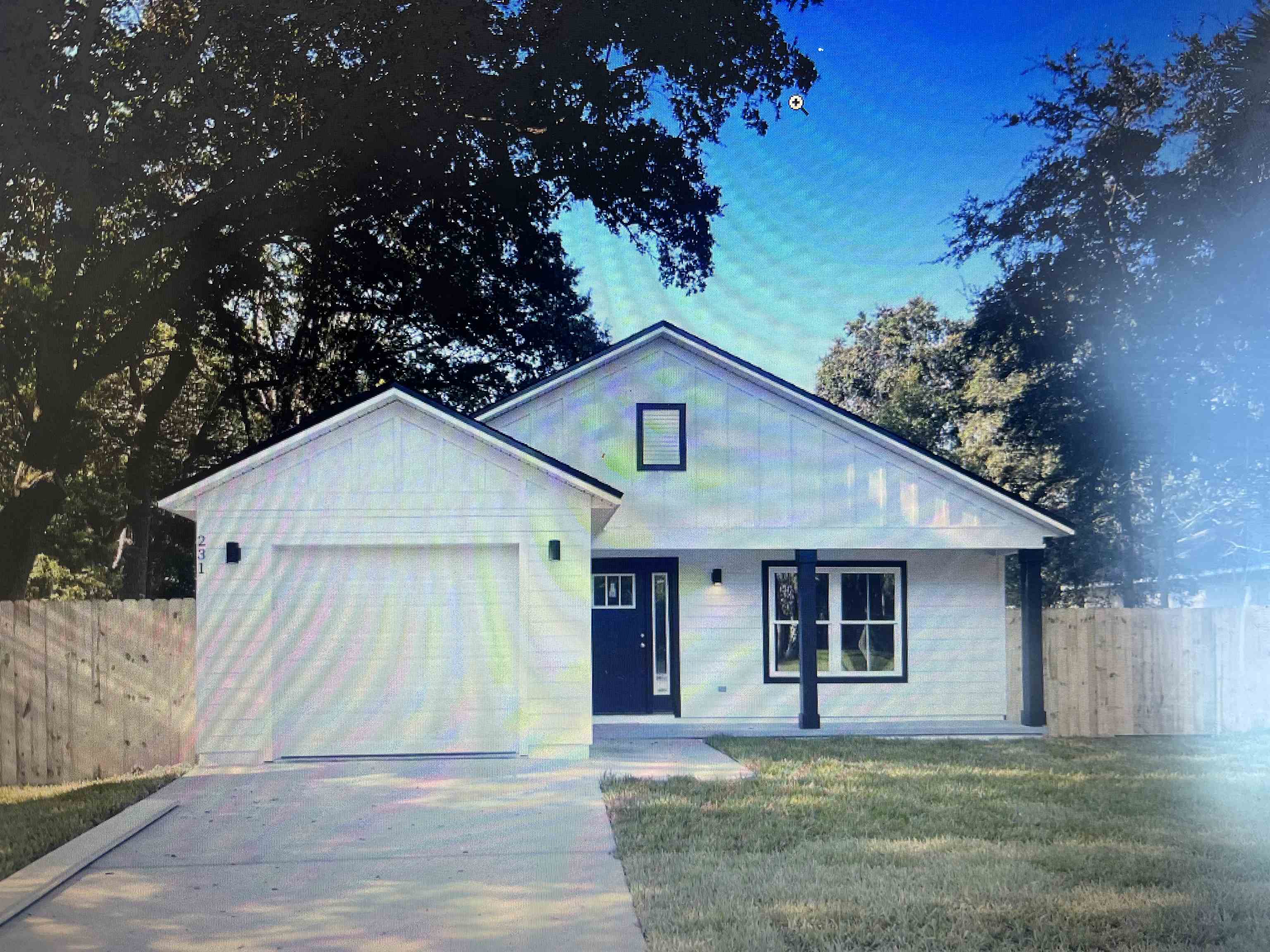 a house that has a tree in front of it