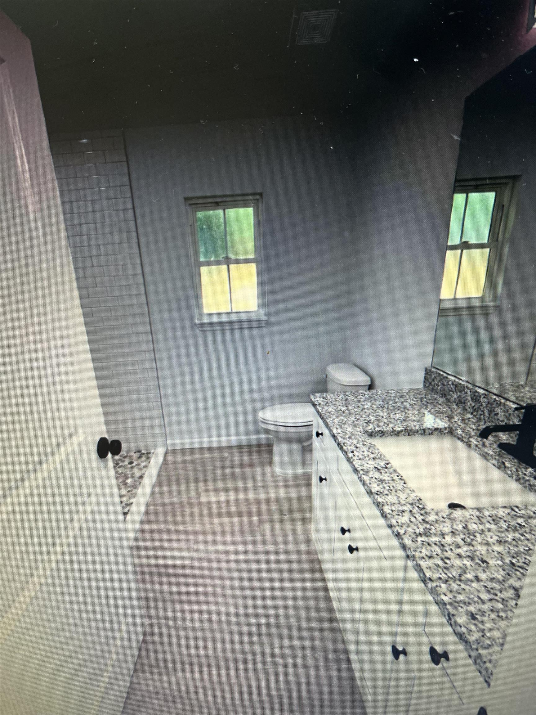 231 Monterey Avenue St. Augustine, FL 32084 - Photo 11 of 15 a bathroom with a granite countertop sink and a mirror
