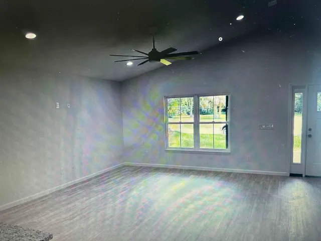 an empty room with a empty space and windows