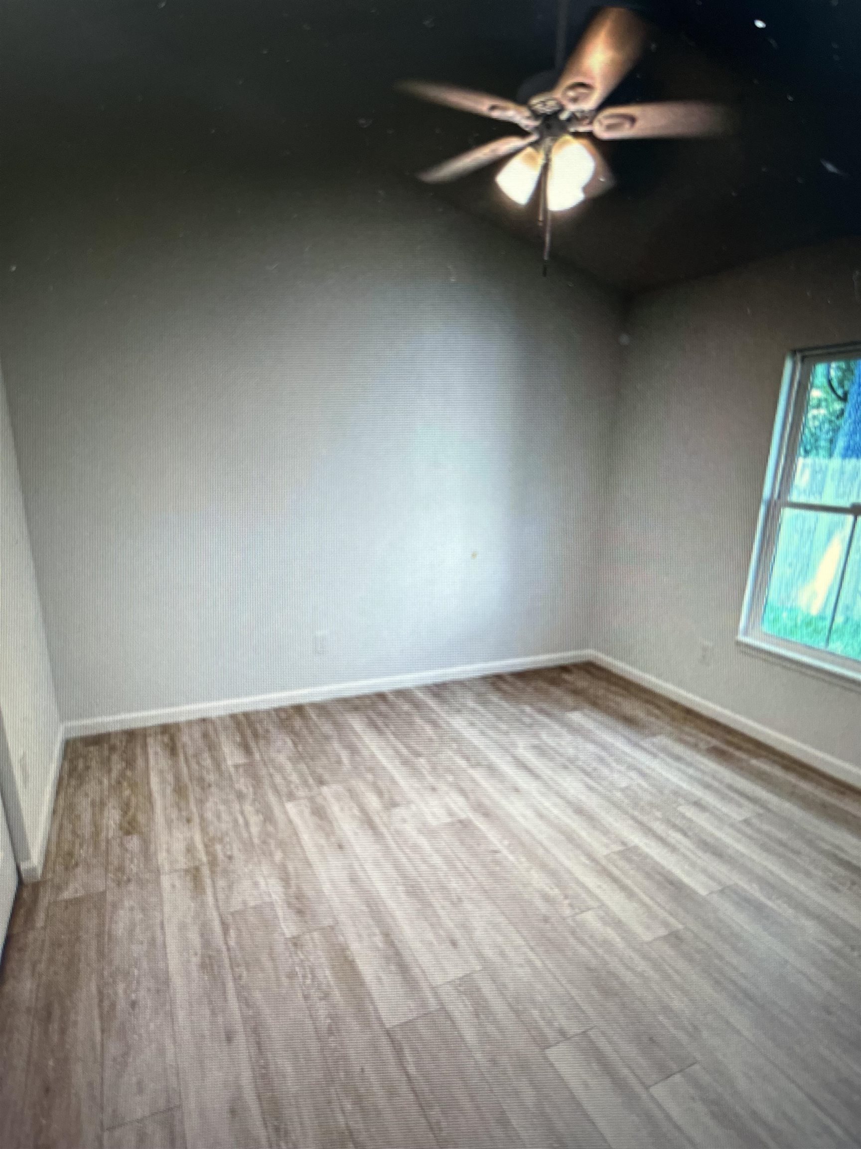 231 Monterey Avenue St. Augustine, FL 32084 - Photo 10 of 15 wooden floor in an empty room with a window