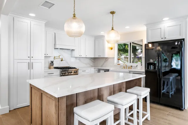 a kitchen with a sink cabinets and refrigerator