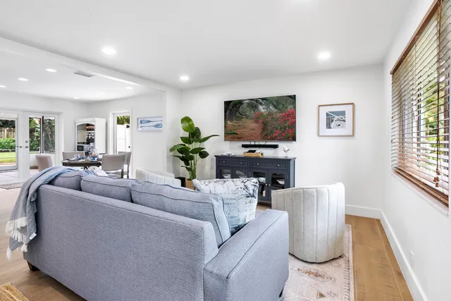 a living room with furniture a dining table and a flat screen tv