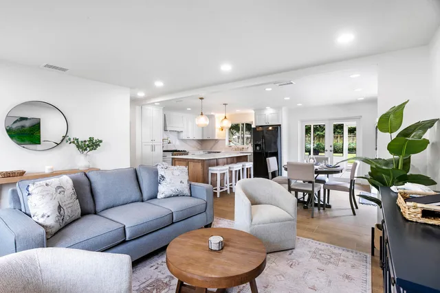 a living room with furniture and kitchen view