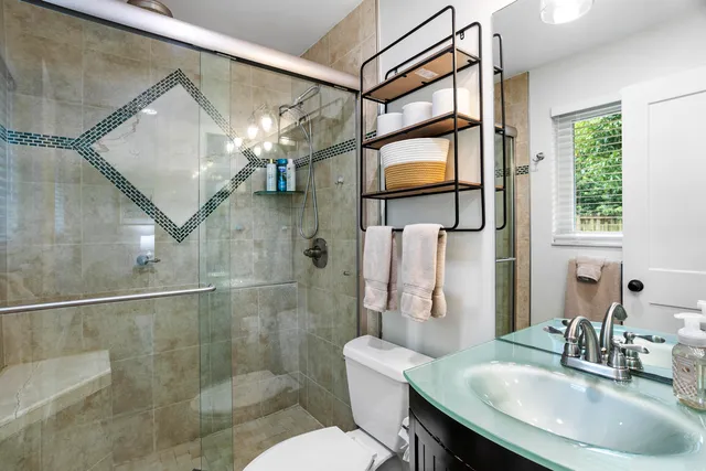 a bathroom with a sink toilet and shower