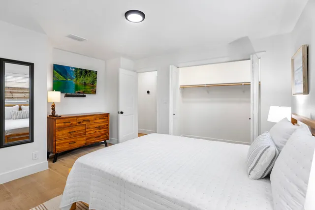 a bedroom with a bed and a flat screen tv