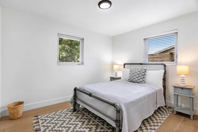 a bedroom with a bed and a lamp