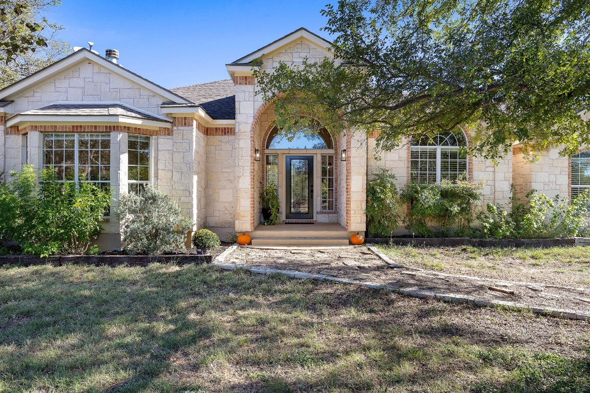 a front view of a house with garden