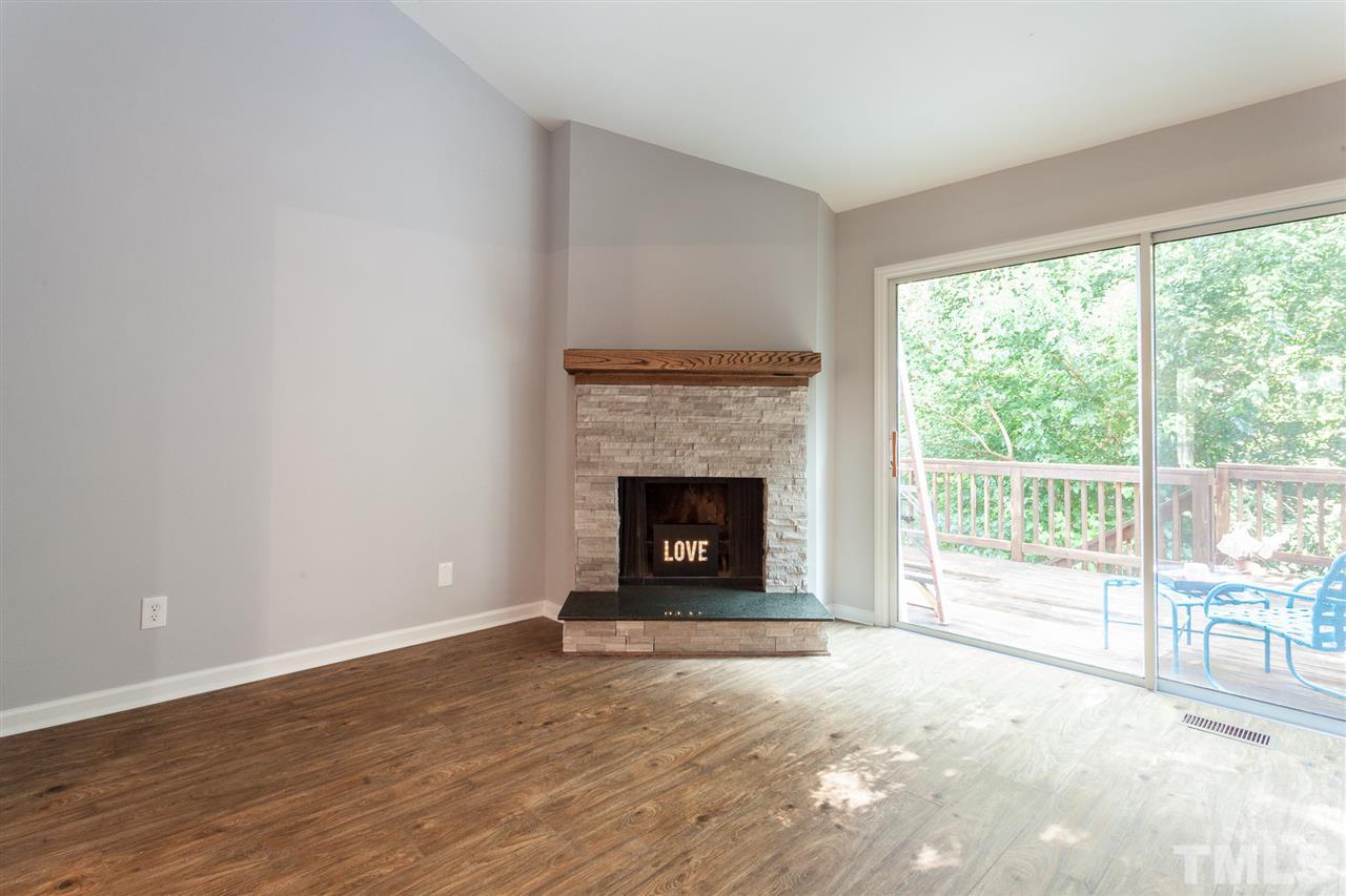 5839 Branchwood Road Raleigh, NC 27609 - Photo 14 of 25 a view of an empty room with wooden floor and a window