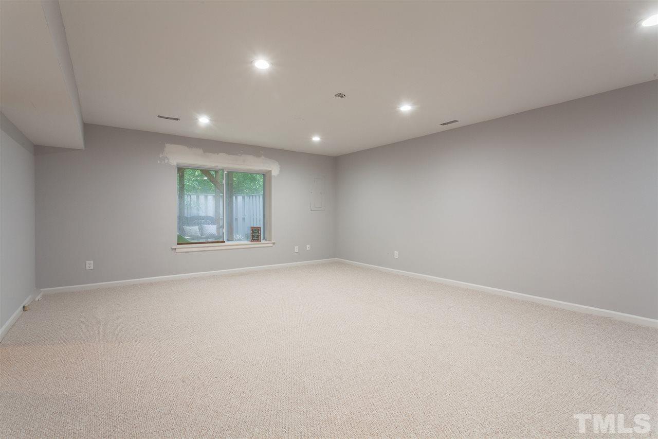 5839 Branchwood Road Raleigh, NC 27609 - Photo 22 of 25 an empty room with windows