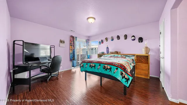 a bedroom with furniture and a flat screen tv