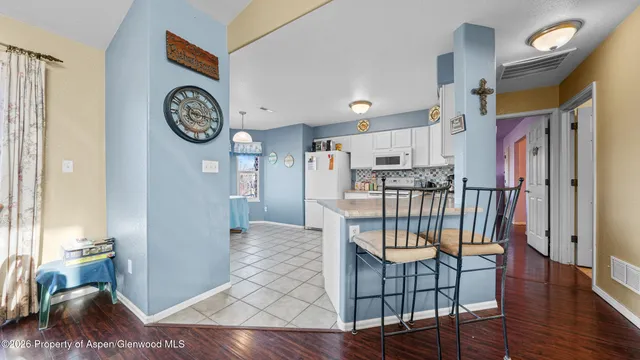 a dining room with furniture and wooden floor