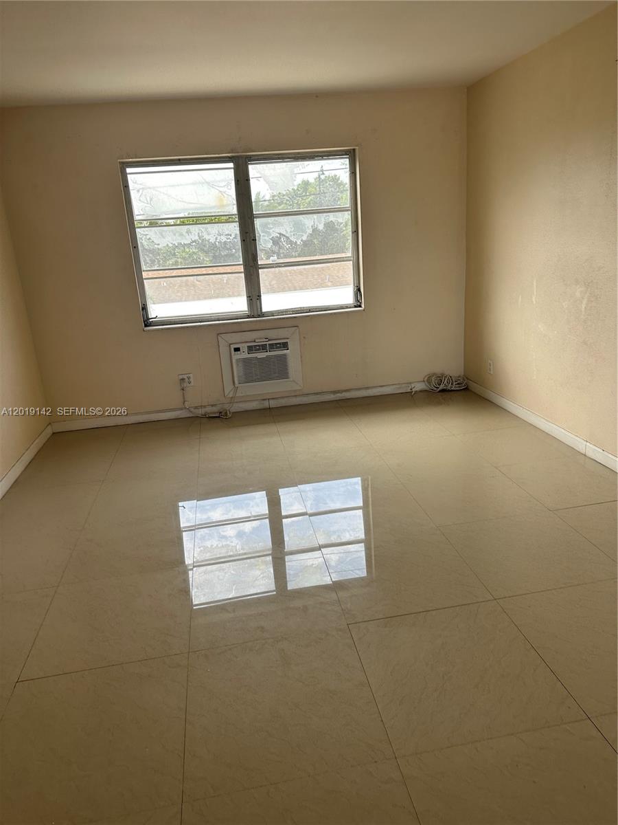 1050 East Sample Road, Unit 208 Pompano Beach, FL 33064 - Photo 2 of 9 an empty room with a empty space and window