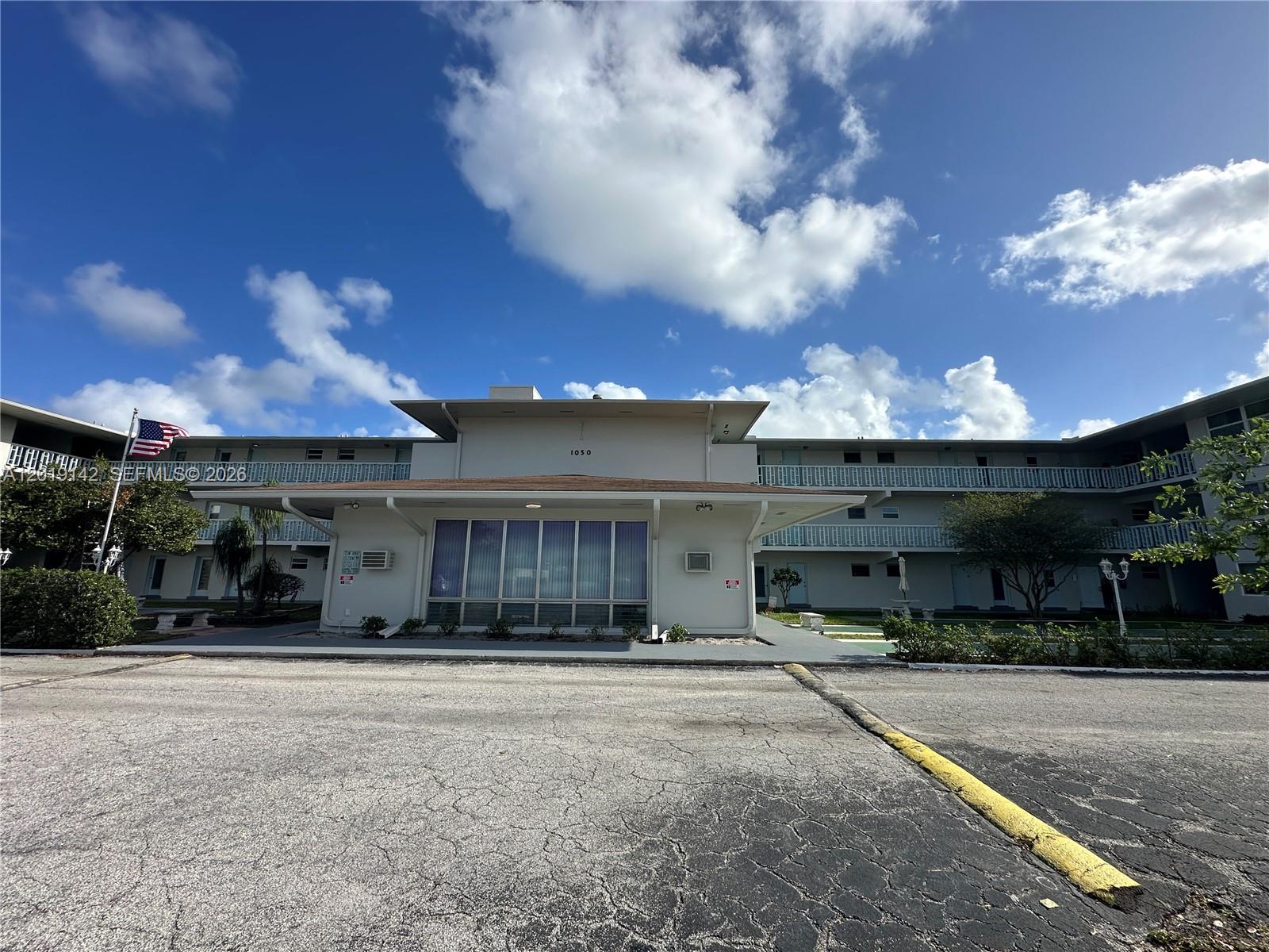 1050 East Sample Road, Unit 208 Pompano Beach, FL 33064 - Photo 5 of 9 a view of a house with a yard