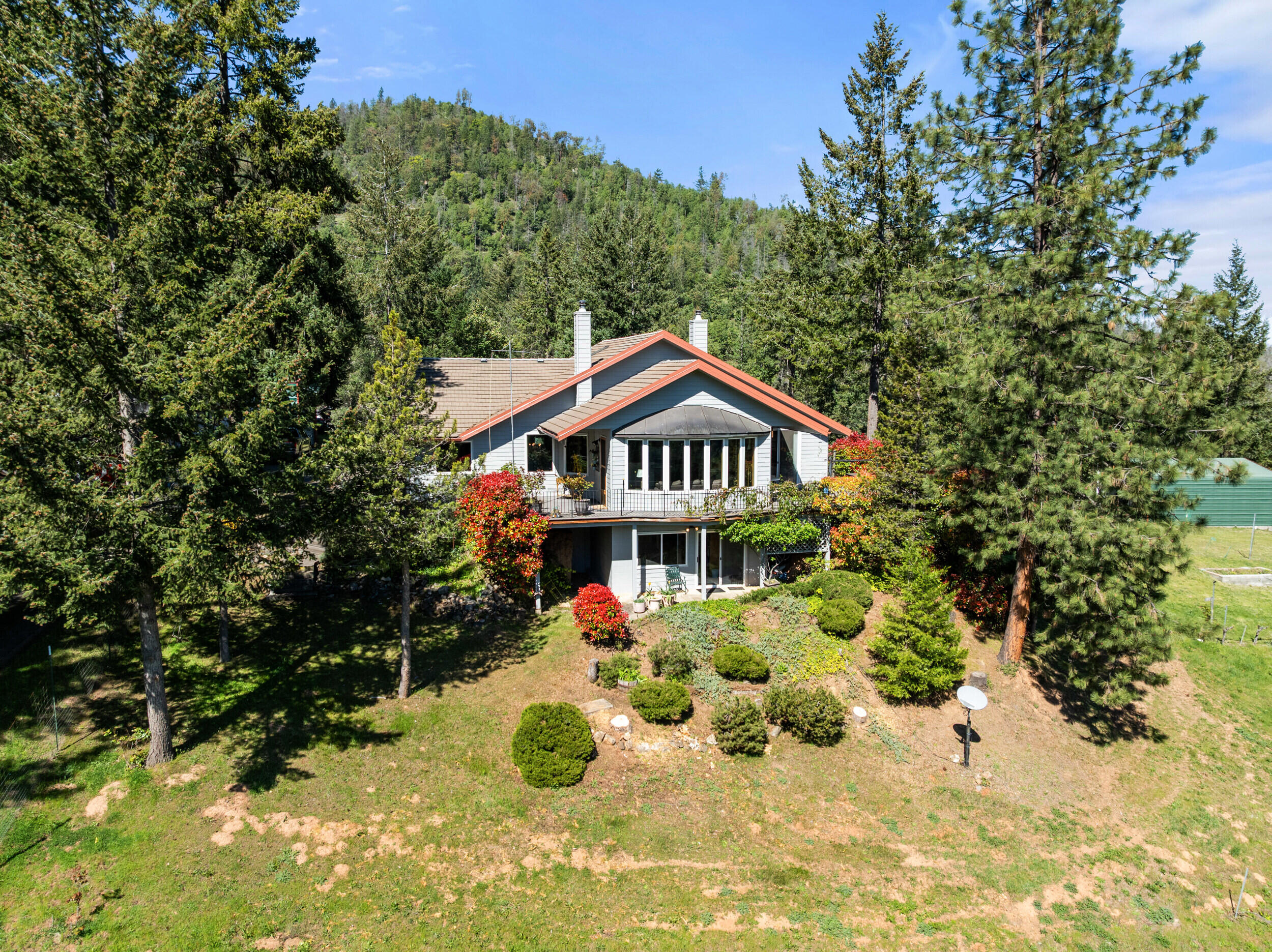 9302 Yank Gulch Road Talent, OR 97540 - Photo 3 of 37 a front view of a house with a yard
