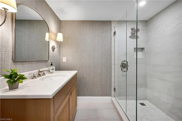 a bathroom with a double vanity sink mirror and shower