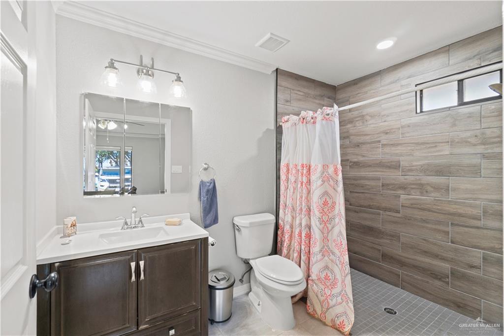 9230 North Moorefield Road Mission, TX 78574 - Photo 13 of 27 a bathroom with a sink a toilet and shower