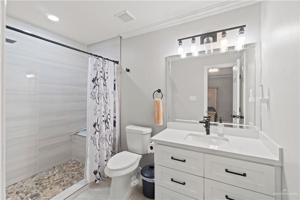 9230 North Moorefield Road Mission, TX 78574 - Photo 15 of 27 a bathroom with a sink a toilet and shower
