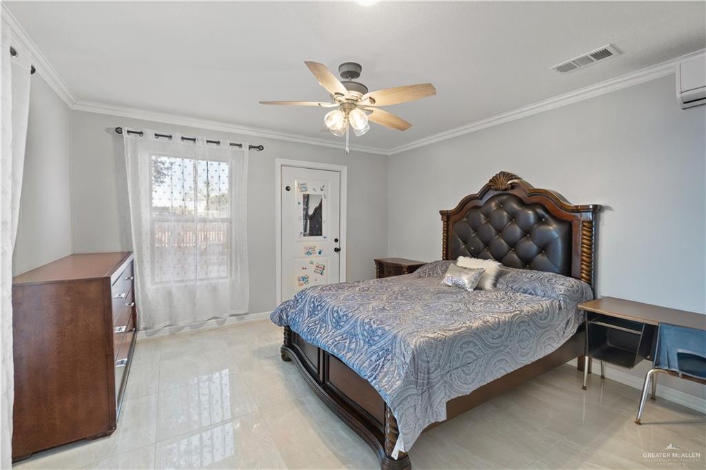 9230 North Moorefield Road Mission, TX 78574 - Photo 16 of 27 a bedroom with a bed and window