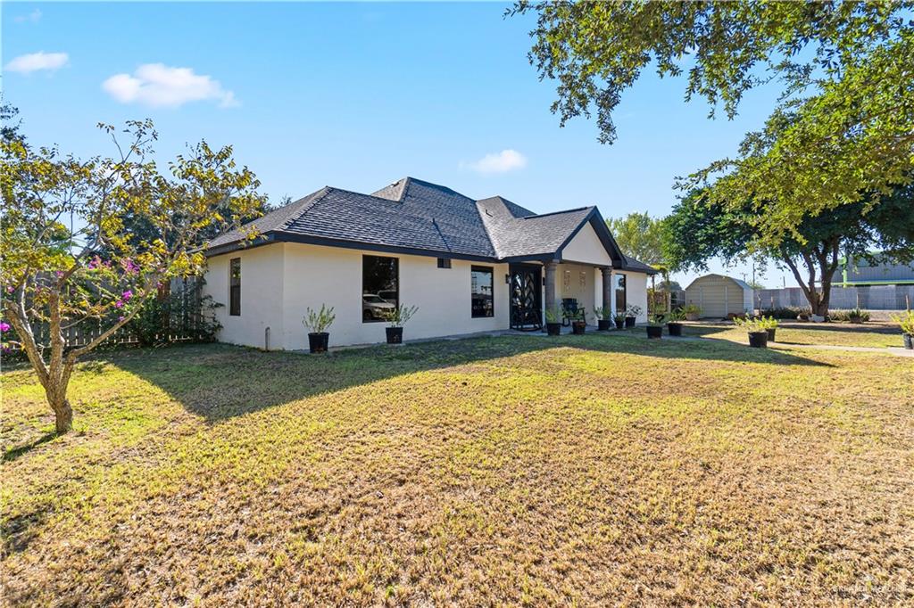 9230 North Moorefield Road Mission, TX 78574 - Photo 2 of 27 a view of a house with a yard and garage
