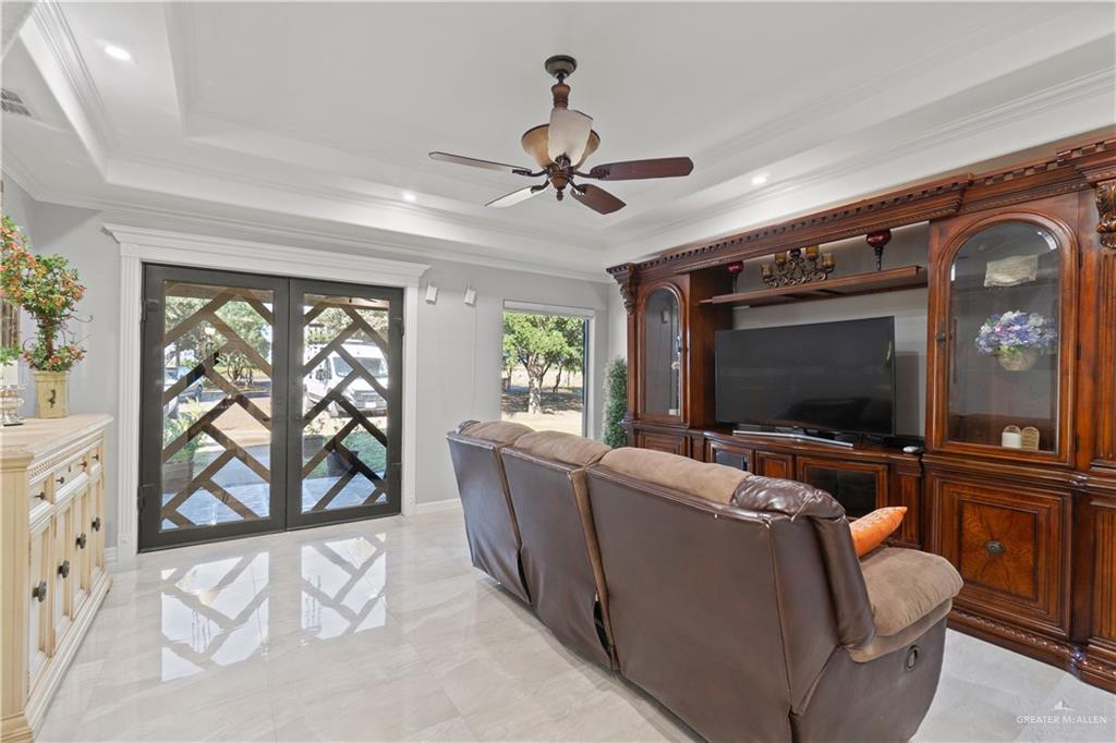9230 North Moorefield Road Mission, TX 78574 - Photo 3 of 27 a living room with furniture and a flat screen tv