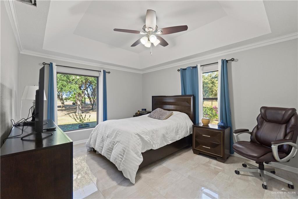 9230 North Moorefield Road Mission, TX 78574 - Photo 10 of 27 a bedroom with a bed and a chair