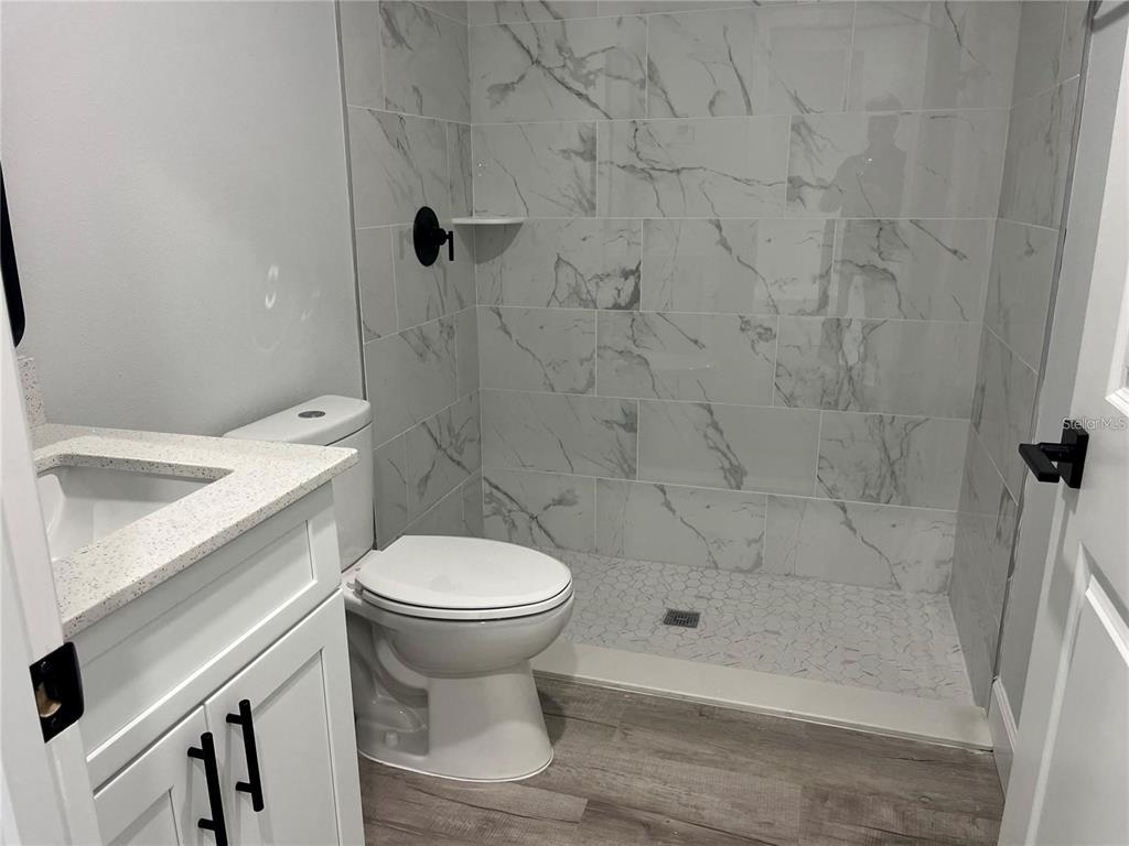 7213 Ancha Street Sebring, FL 33872 - Photo 11 of 18 a bathroom with a shower and toilet