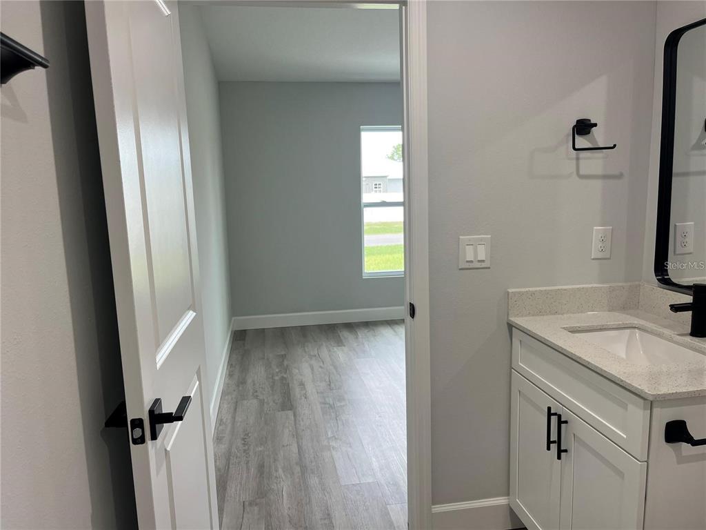 7213 Ancha Street Sebring, FL 33872 - Photo 9 of 18 a bathroom with a sink and a mirror