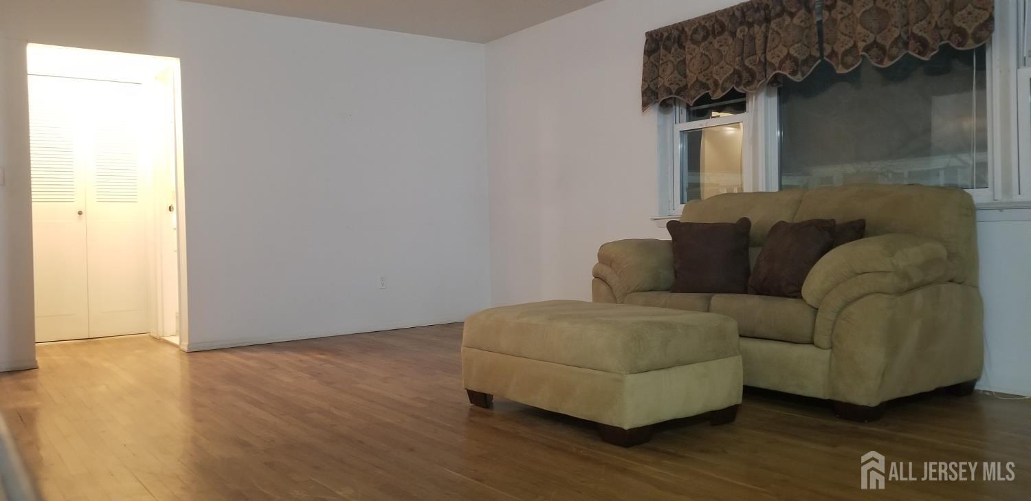 27 Judson Street, Unit 13B Edison, NJ 08837 - Photo 12 of 21 a living room with furniture and a wooden floor