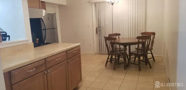 a kitchen with stainless steel appliances a table and chairs