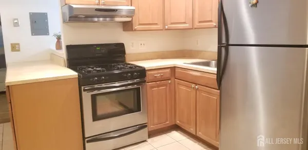 a kitchen with a stove and a refrigerator