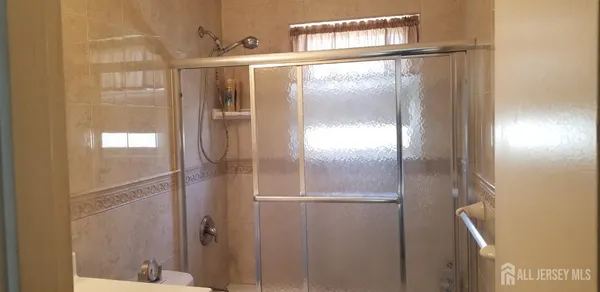 a bathroom with a glass shower door
