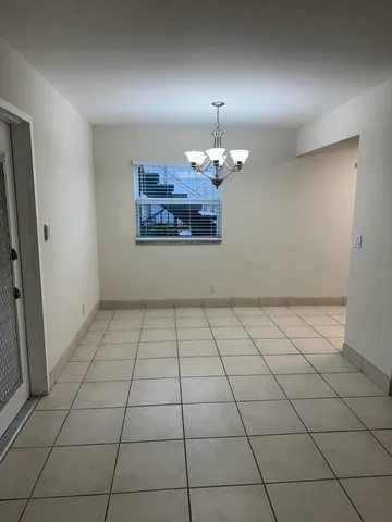 a kitchen with a refrigerator sink and cabinets
