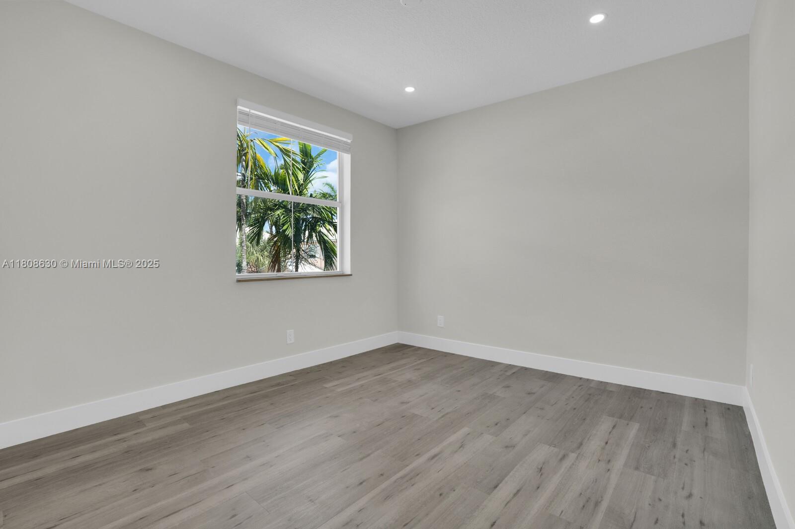 4123 Parkside Drive Jupiter, FL 33458 - Photo 13 of 39 a view of room with wooden floor and window