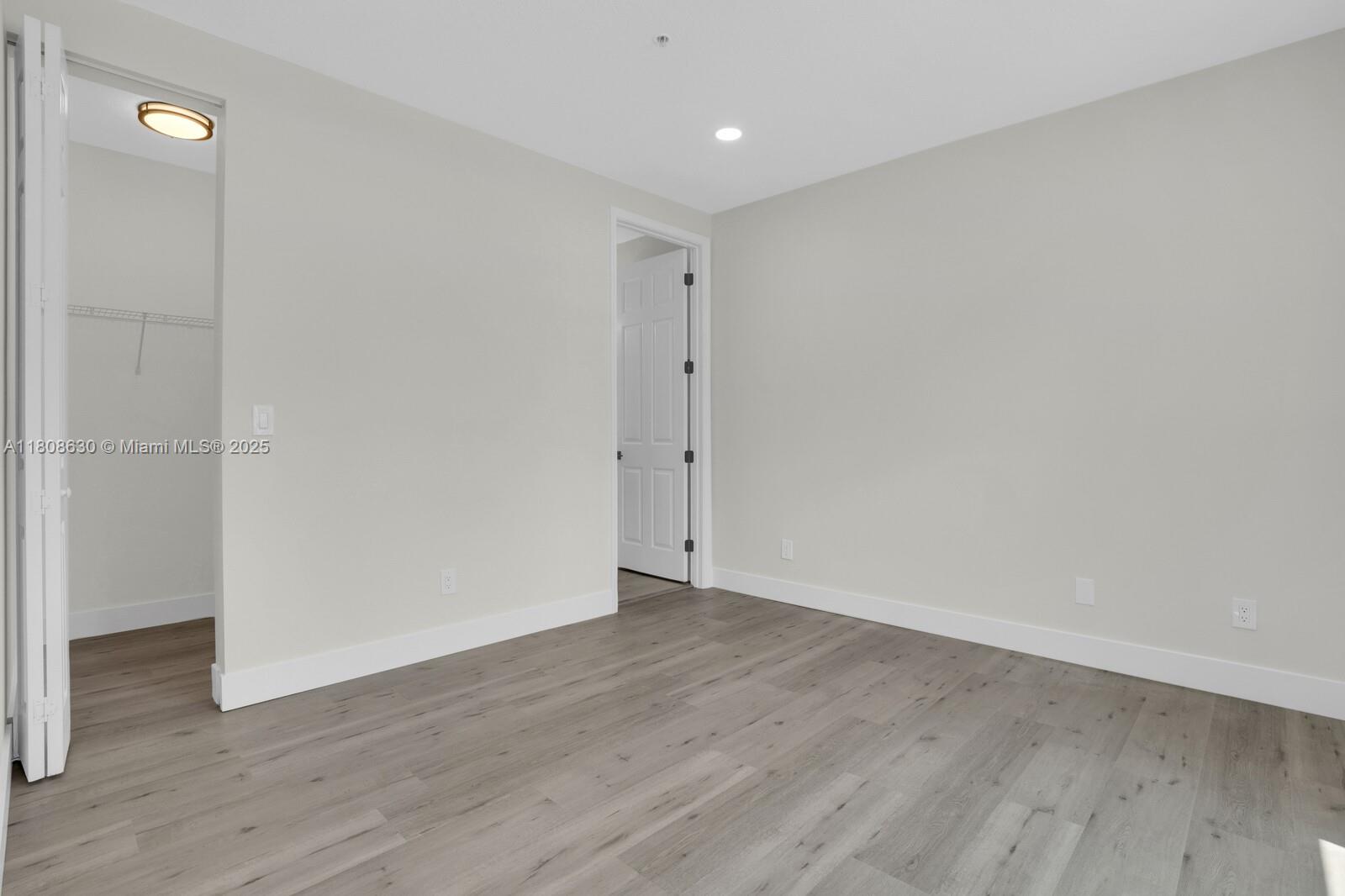 4123 Parkside Drive Jupiter, FL 33458 - Photo 17 of 39 a view of an empty room with wooden floor