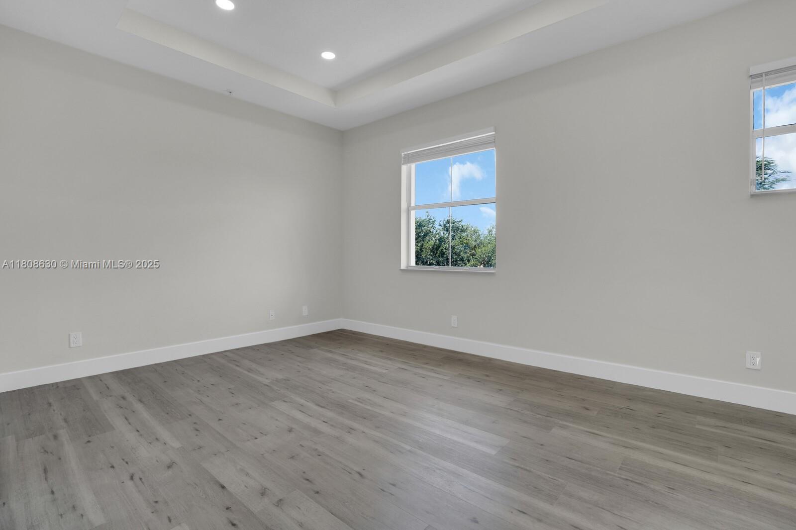 4123 Parkside Drive Jupiter, FL 33458 - Photo 22 of 39 a view of an empty room with wooden floor and a window