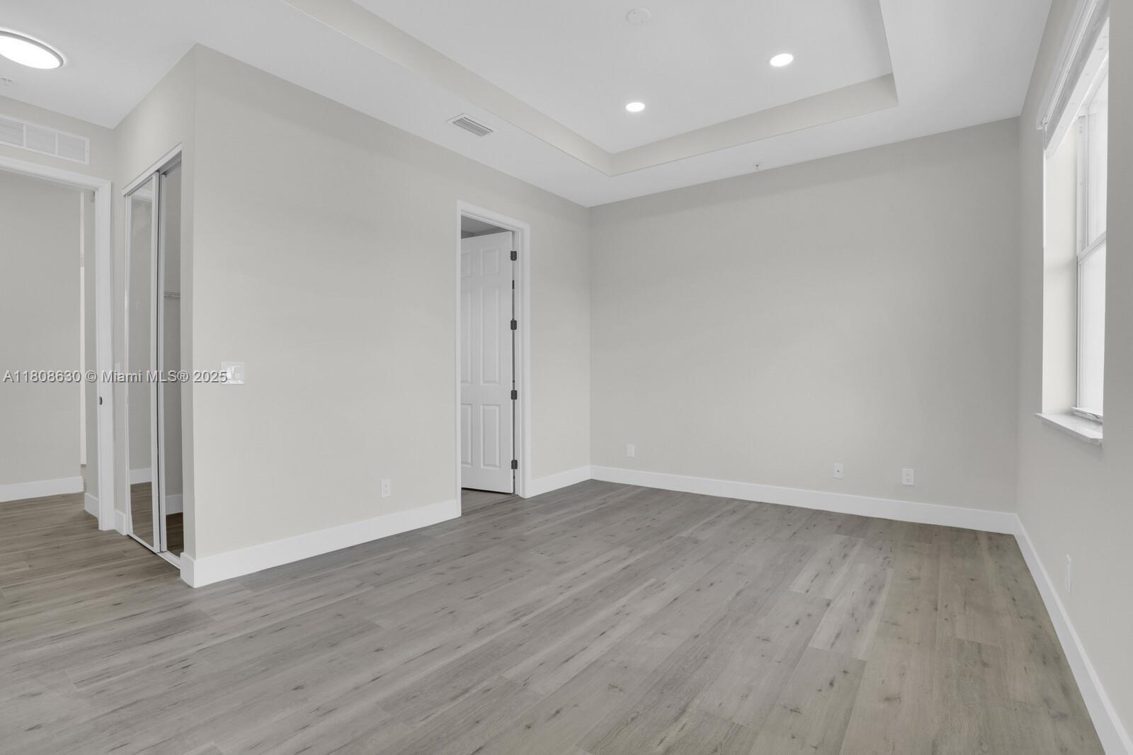 4123 Parkside Drive Jupiter, FL 33458 - Photo 23 of 39 an empty room with wooden floor and window