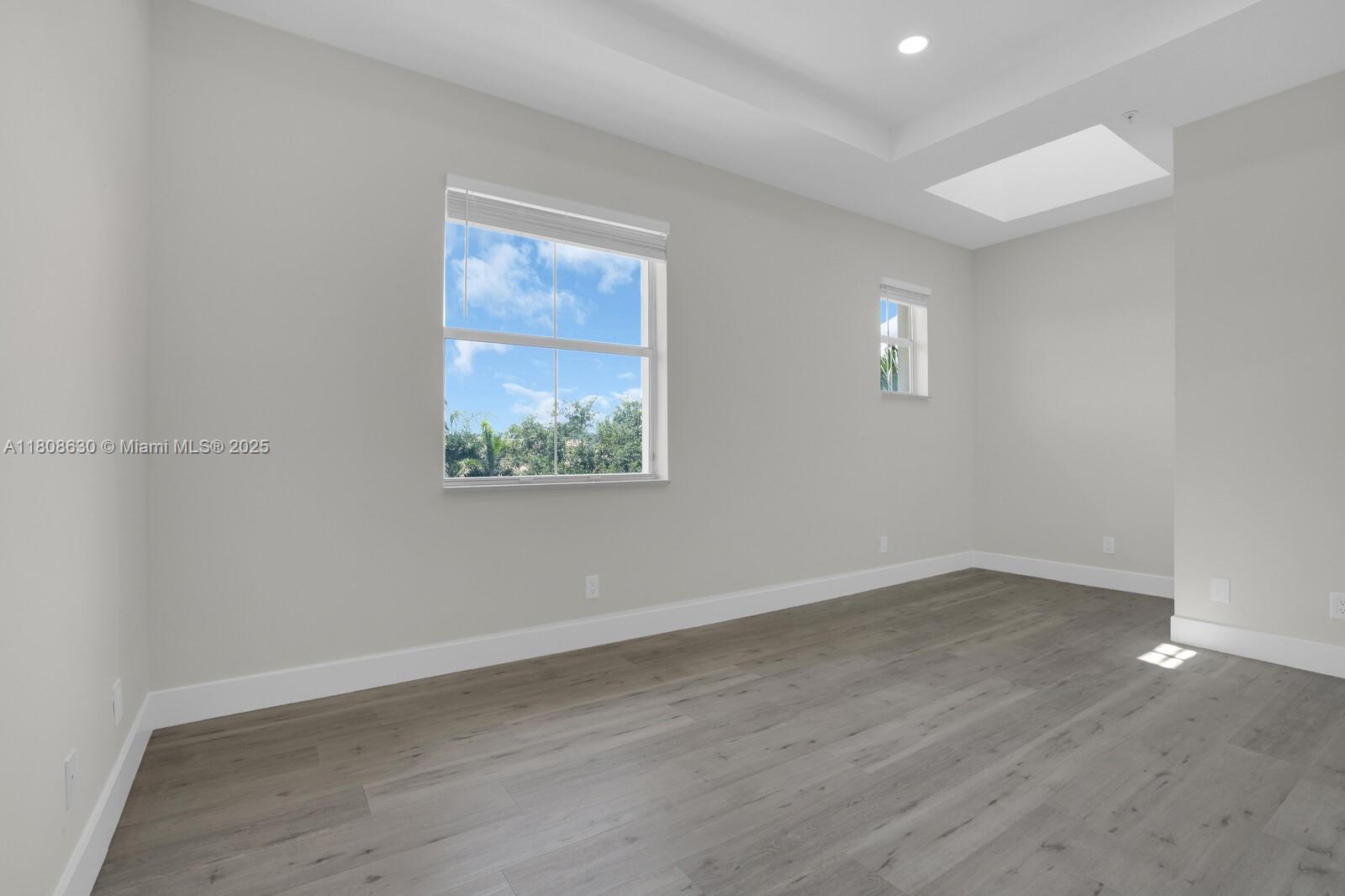 4123 Parkside Drive Jupiter, FL 33458 - Photo 24 of 39 an empty room with wooden floor and windows