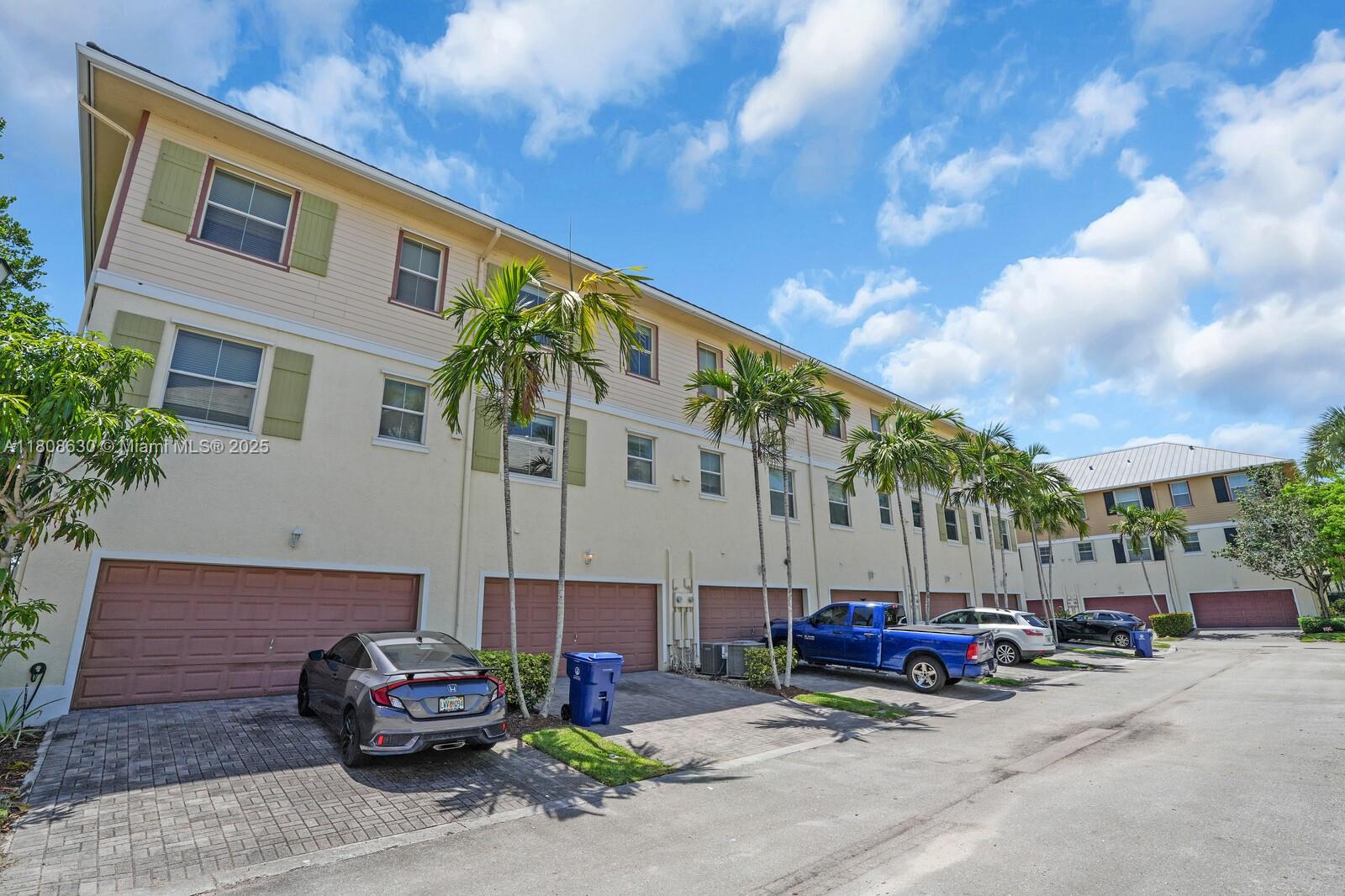 4123 Parkside Drive Jupiter, FL 33458 - Photo 27 of 39 a view of a cars parked in front of a building