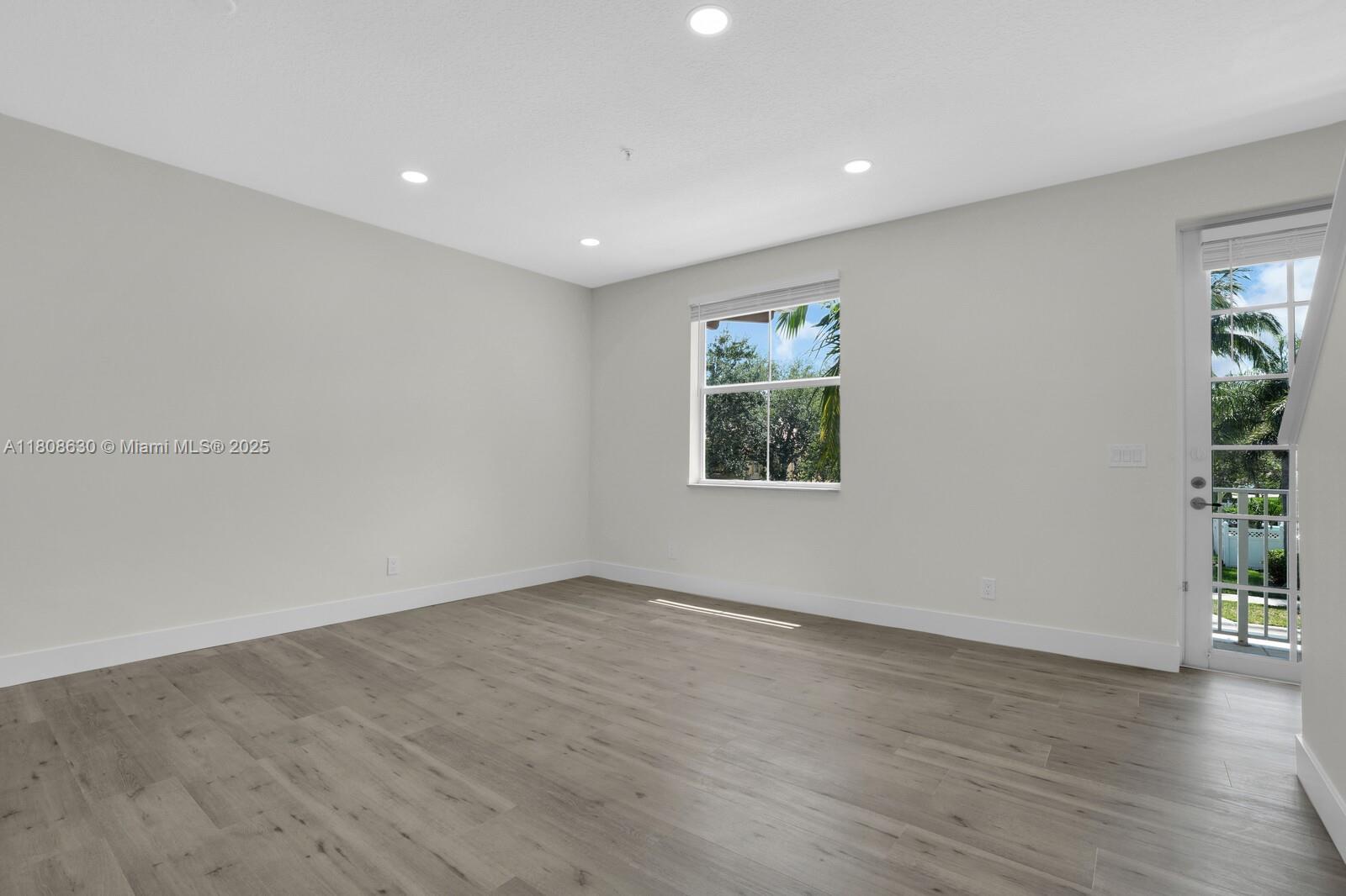 4123 Parkside Drive Jupiter, FL 33458 - Photo 9 of 39 an empty room with window and wooden floor