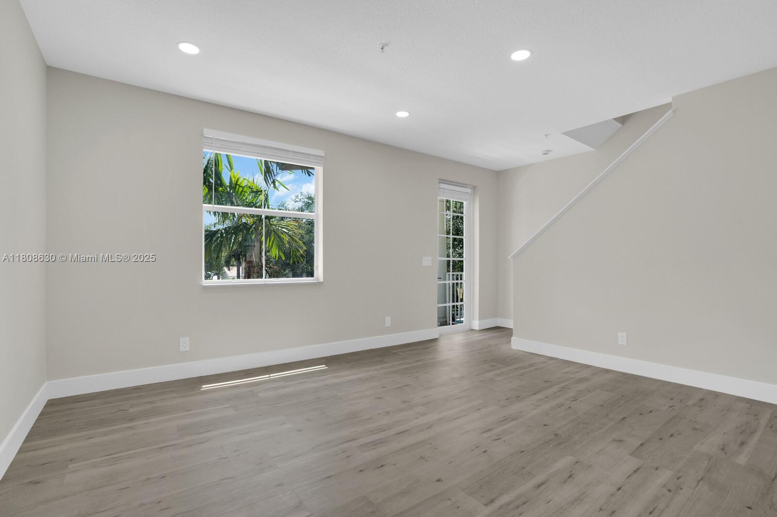 4123 Parkside Drive Jupiter, FL 33458 - Photo 10 of 39 an empty room with wooden floor and windows