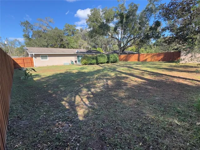 a view of outdoor space with deck and yard