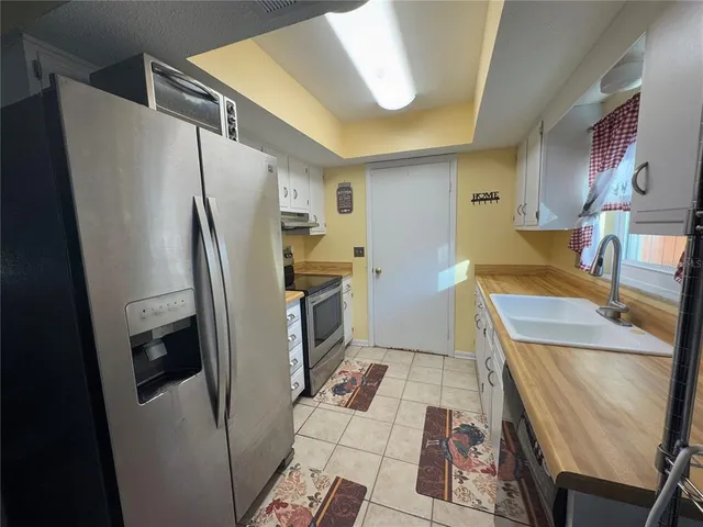 a kitchen with refrigerator and washer