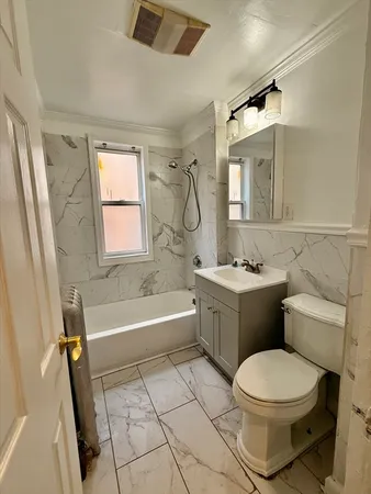 a bathroom with a bathtub toilet and sink