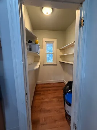 a room with a walk in closet and wooden floor