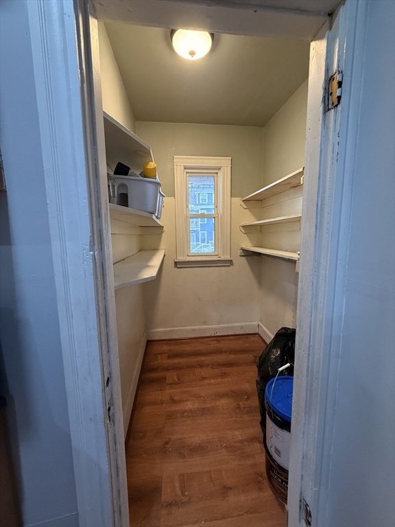 15 Dunlap Street, Unit 1 Boston, MA 02124 - Photo 8 of 8 a room with a walk in closet and wooden floor