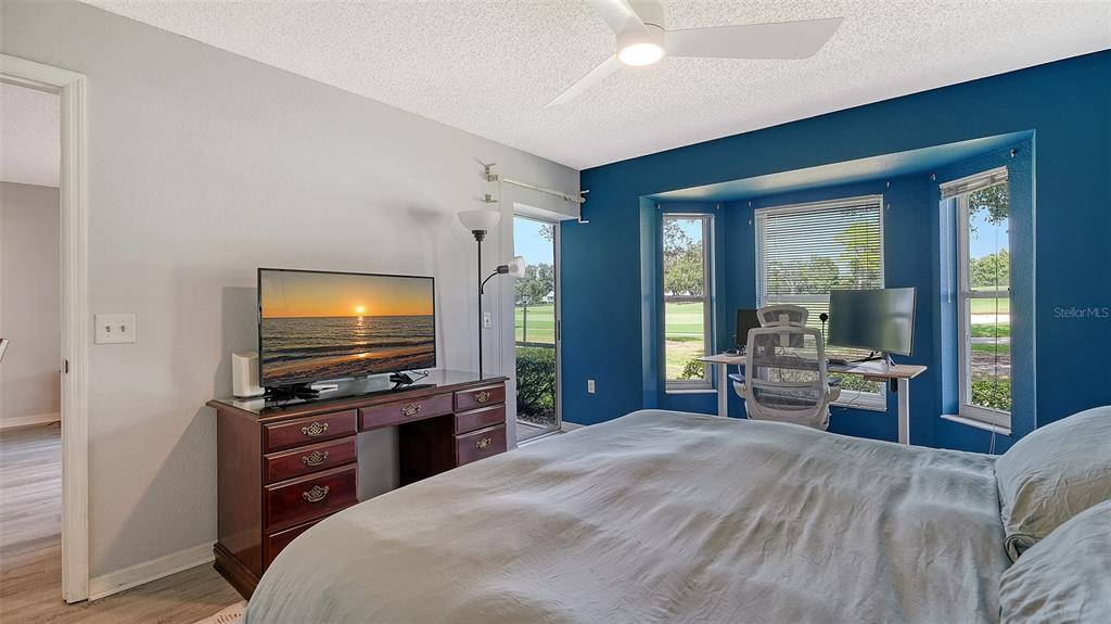 6611 Stone River Road, Unit 103 Bradenton, FL 34203 - Photo 21 of 61 a bedroom with furniture and flat screen tv