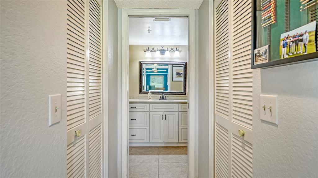 6611 Stone River Road, Unit 103 Bradenton, FL 34203 - Photo 23 of 61 a bathroom with a sink and a mirror